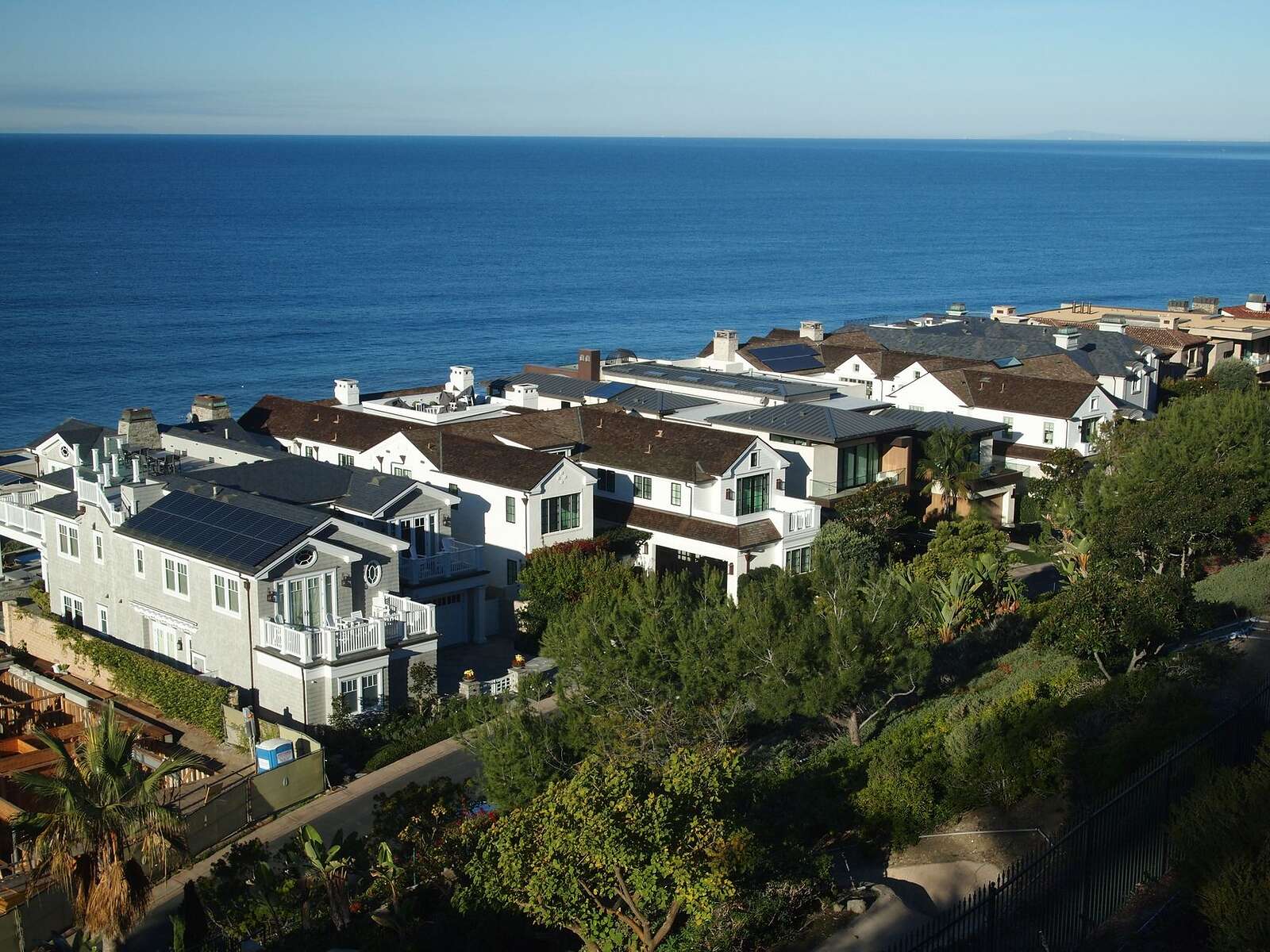 Aerial view of coastal homes on a bluff above the Pacific