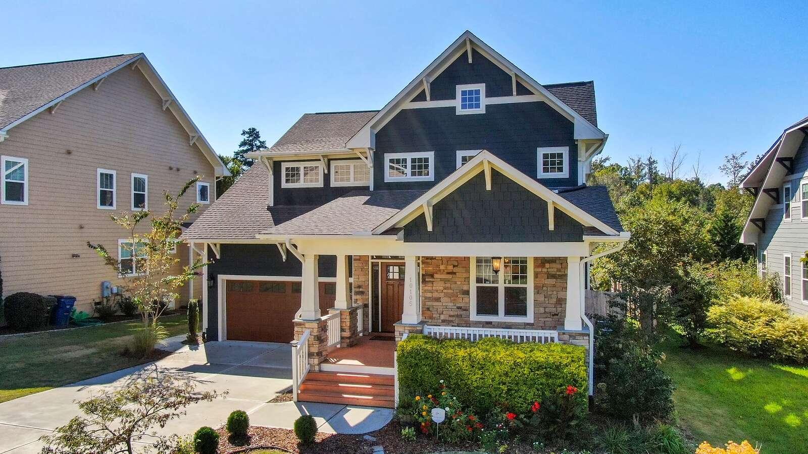 The front of a two-story Craftsman-style house with a covered porch, the kind inspected before a sale